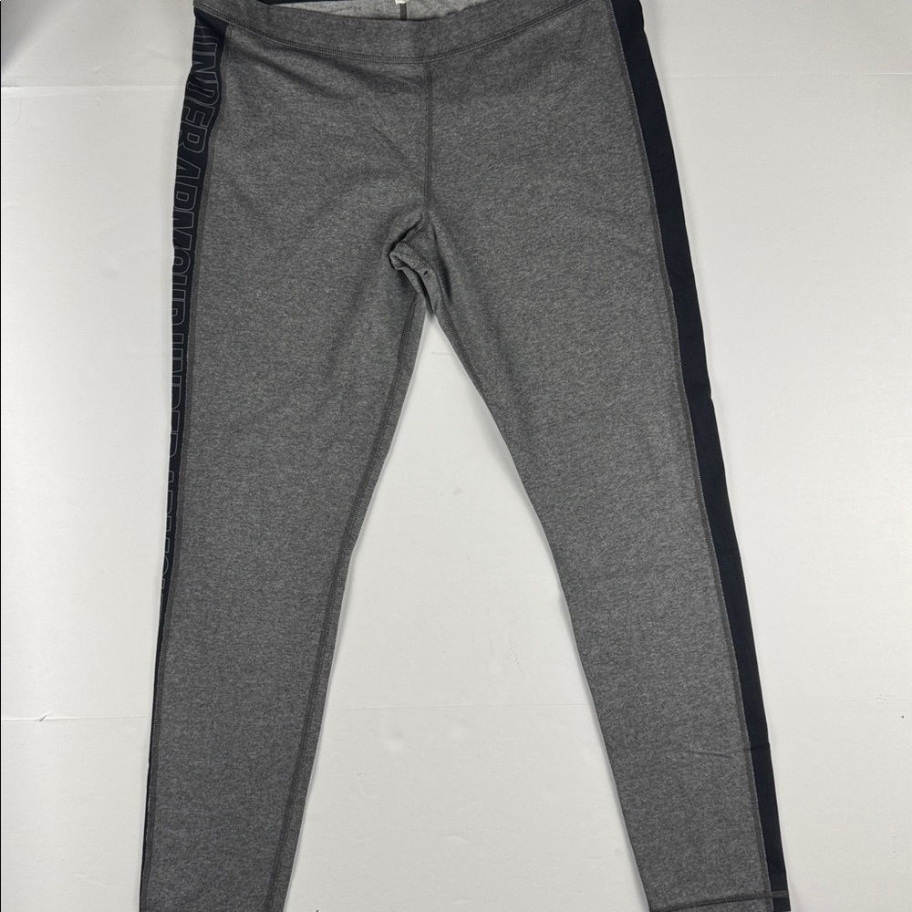 Women’s Under Armour gray leggings with black spell out down the sides
